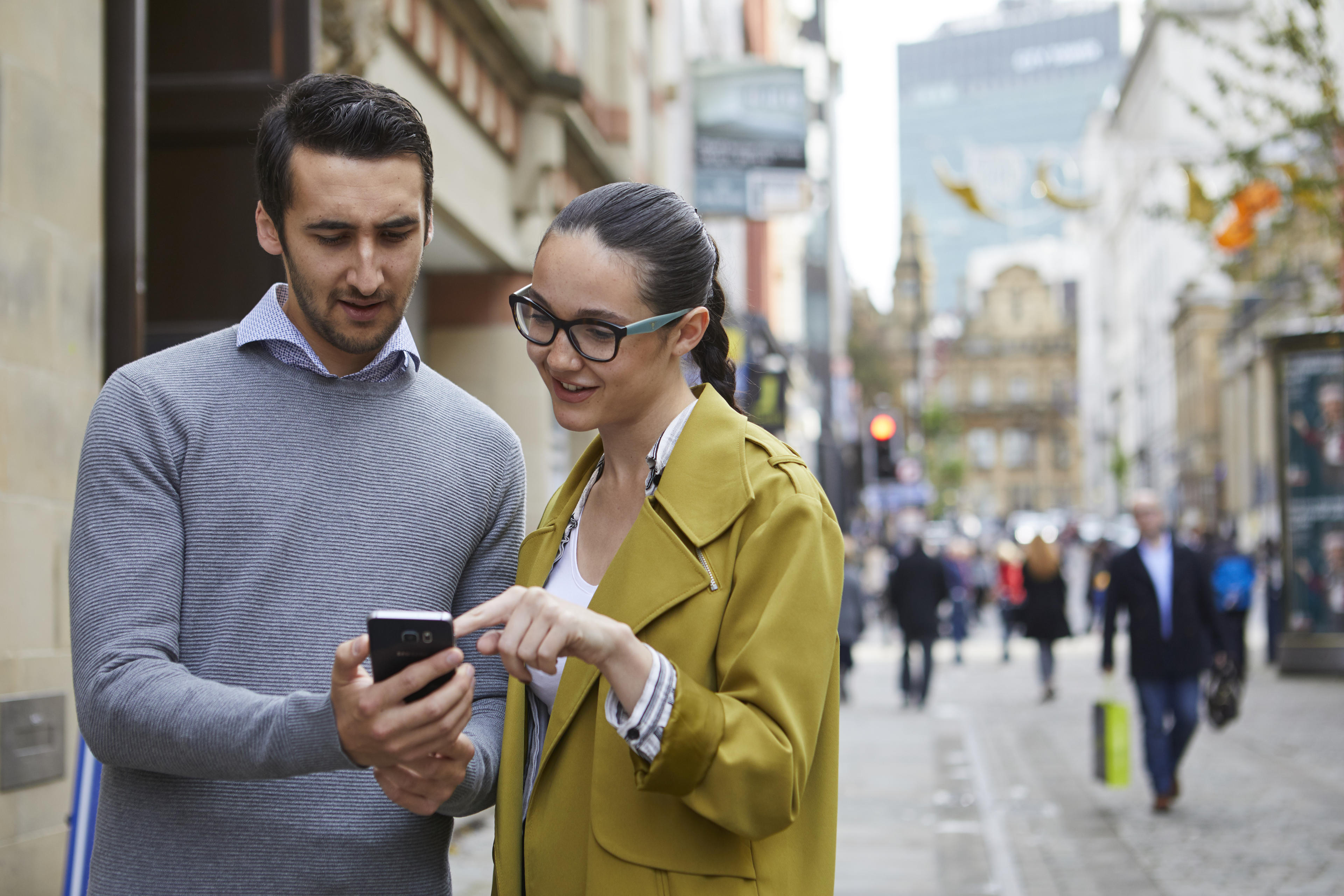 Two people browsing a mobile phone